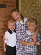 Jake and his sisters in their school uniforms
